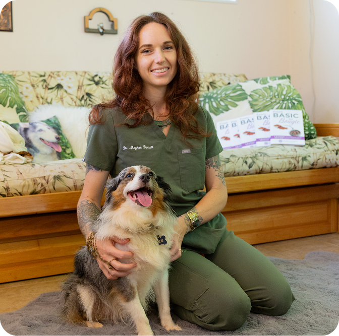 Dr. Meghan Barrett sitting with a dog
